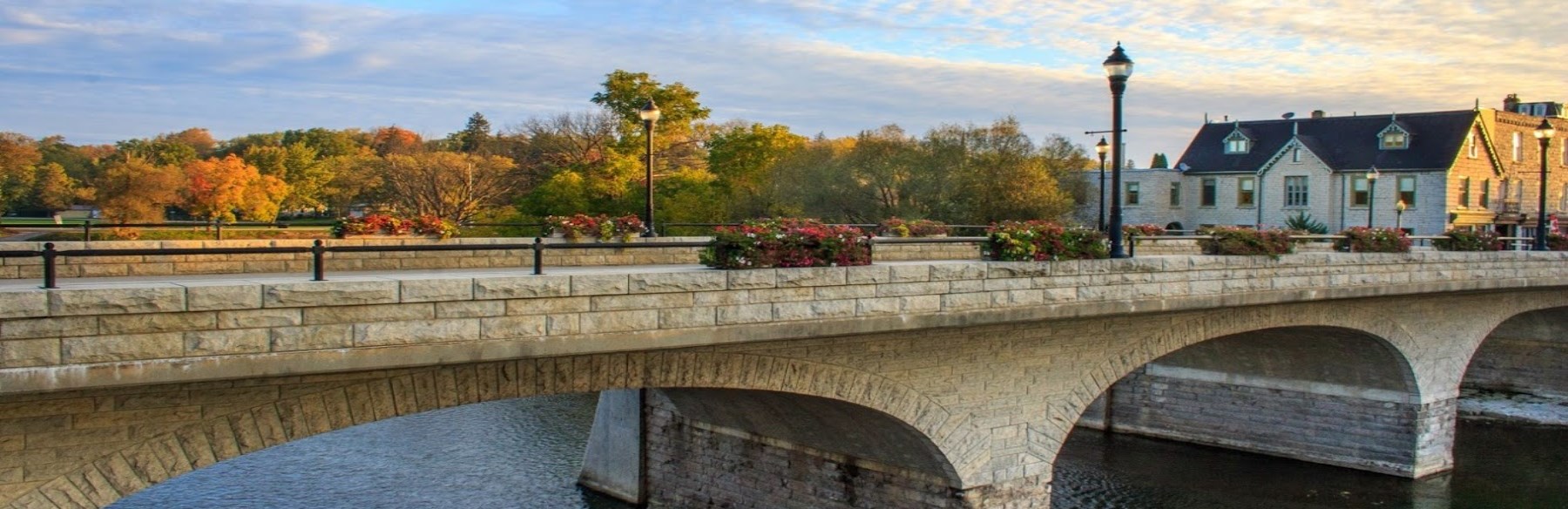 Stone bridge in autumn with tress in the distance