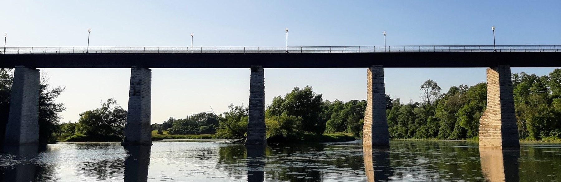 Span of trestle bridge over river 