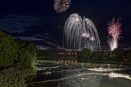 Fireworks over water at night