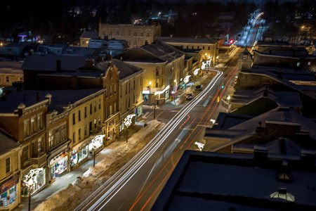Cars passing through the downtown street at night