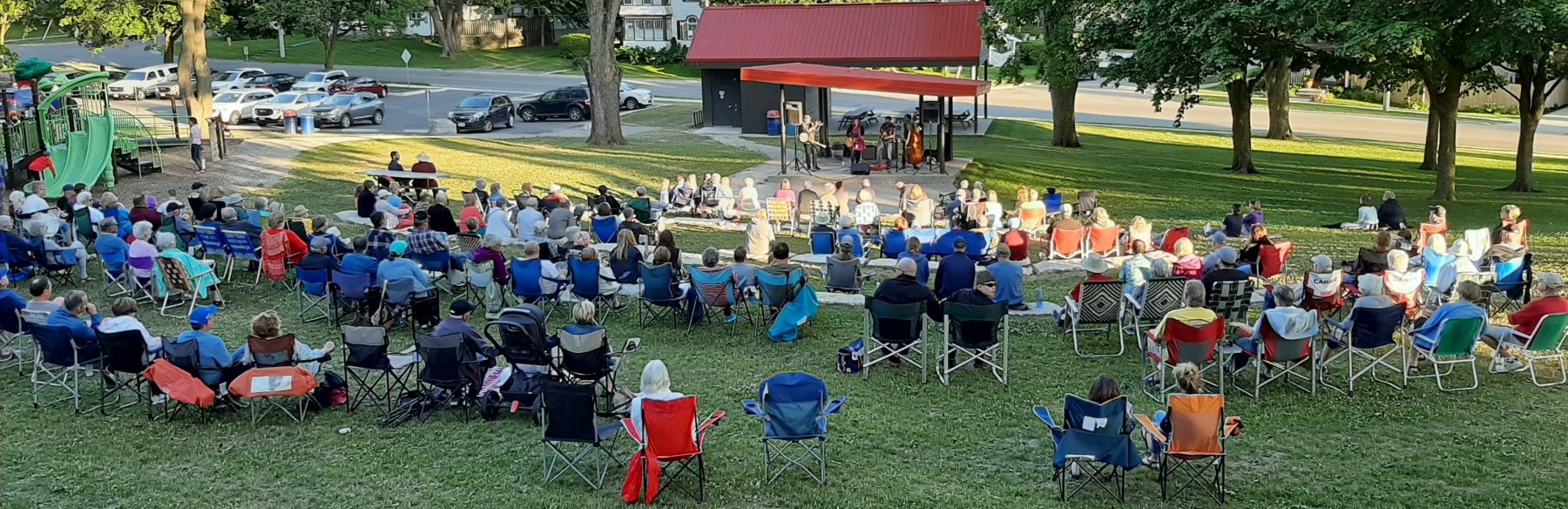 Crowd outdoors watching musicians on stage