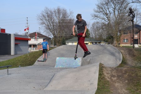 Boy riding scooter at skate park