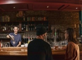 Two people having drink at a bar