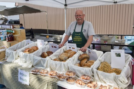 Man behind stand at St. Marys Farmer's Market