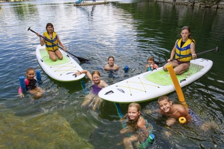 Children on paddle boards and in the water
