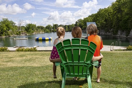 Woman and children sitting in chair in front of the swimming Quarry