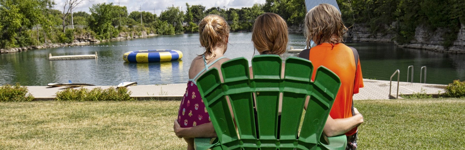 People sitting on chairs facing the water