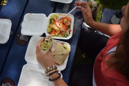 Woman enjoying picnic at table outside