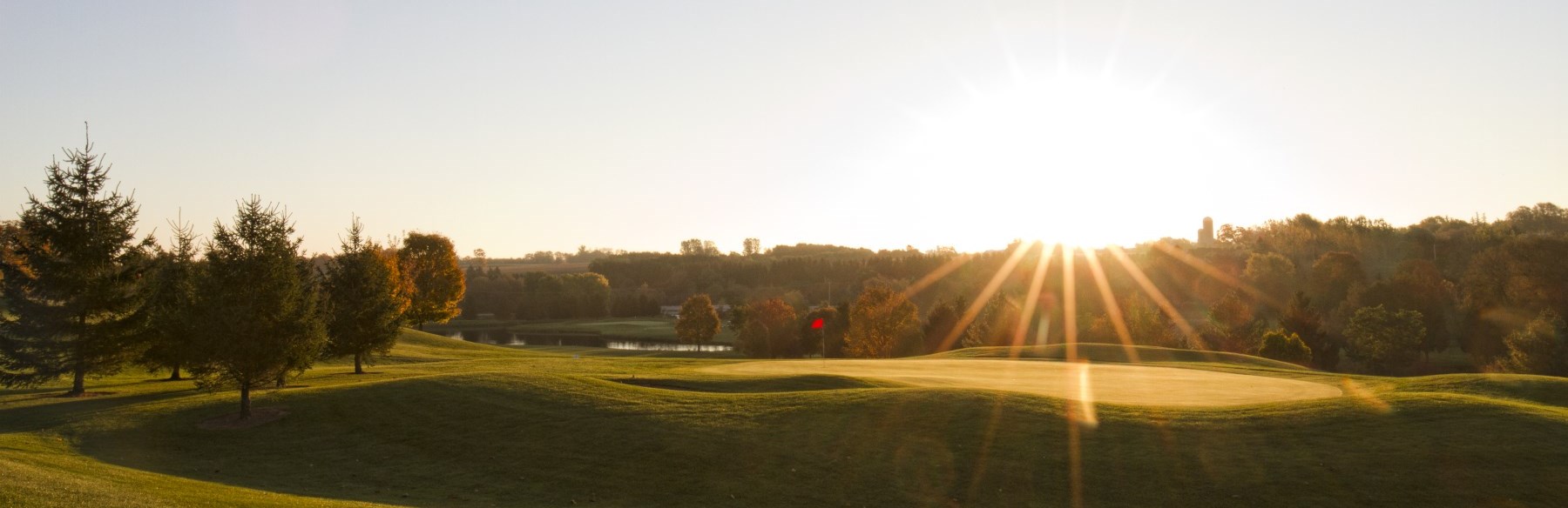 Golf green with sun setting in the background