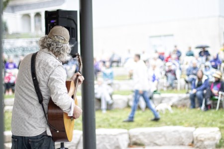 Musician playing guitar for a crowd