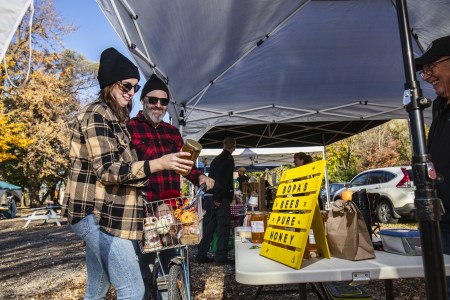 Two people at Farmers' Market vendor stand