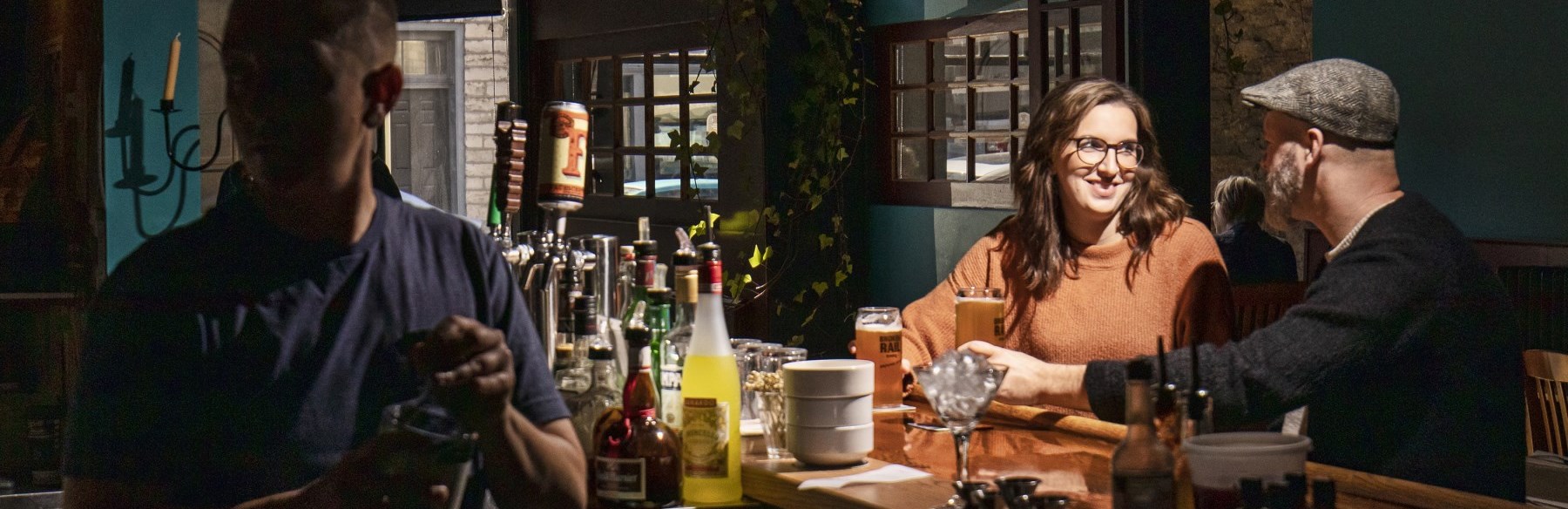 Two people sitting at bar