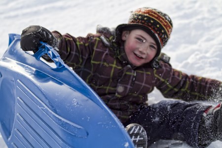 Boy on sled in winter