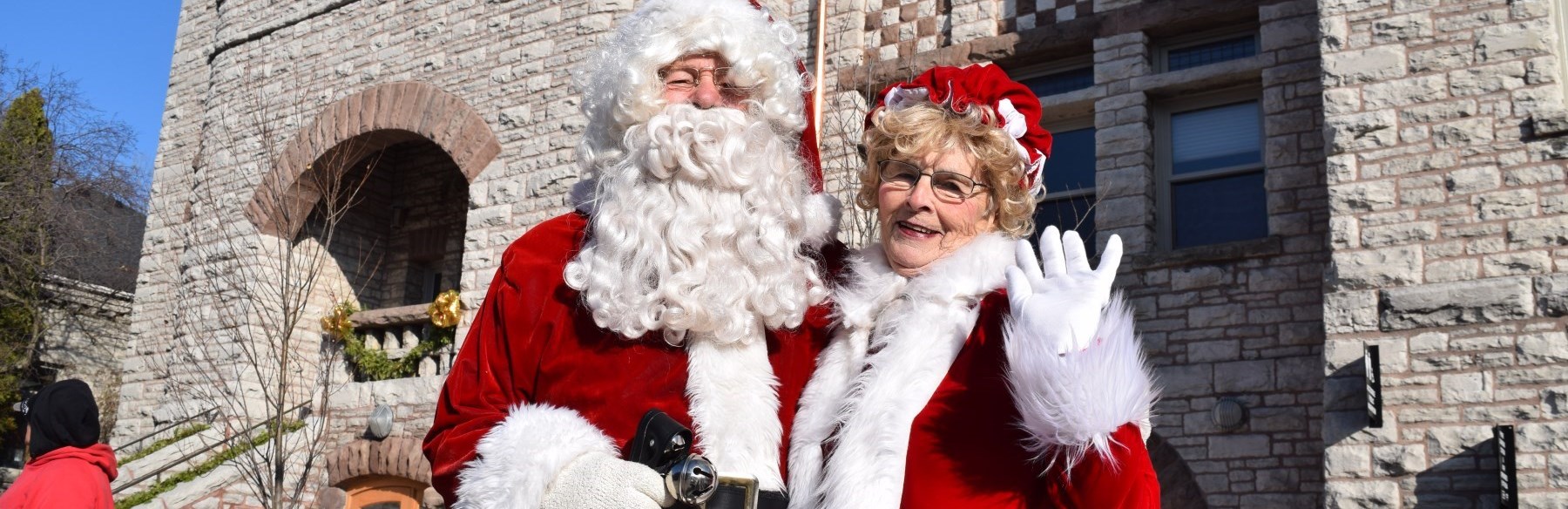 Mr. and Mrs. Clause standing outside